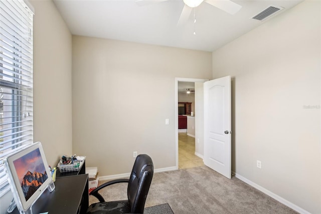 office with light carpet and ceiling fan