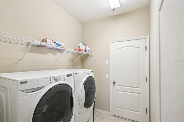 washroom featuring light tile patterned flooring and washing machine and dryer