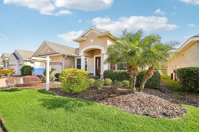 view of front of home featuring a front yard and a garage