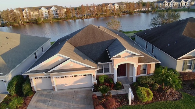 exterior space with a water view and a garage