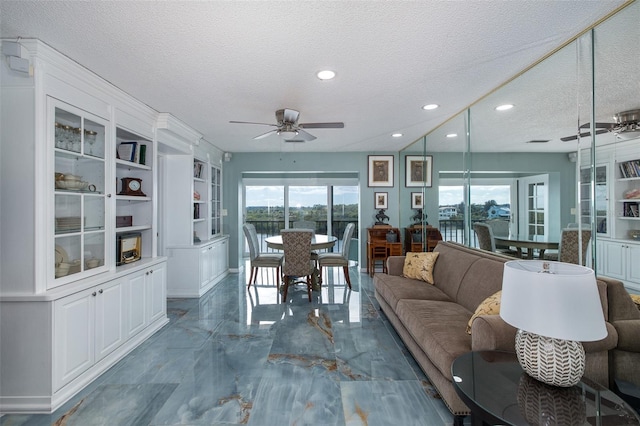 sunroom featuring ceiling fan