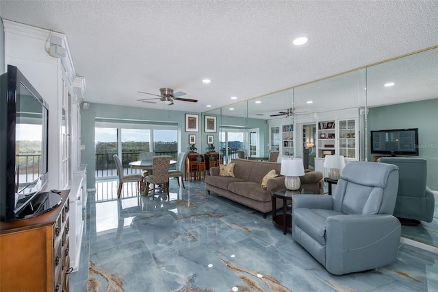 living room featuring a textured ceiling, ceiling fan, and built in features