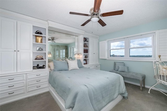 carpeted bedroom with a textured ceiling and ceiling fan