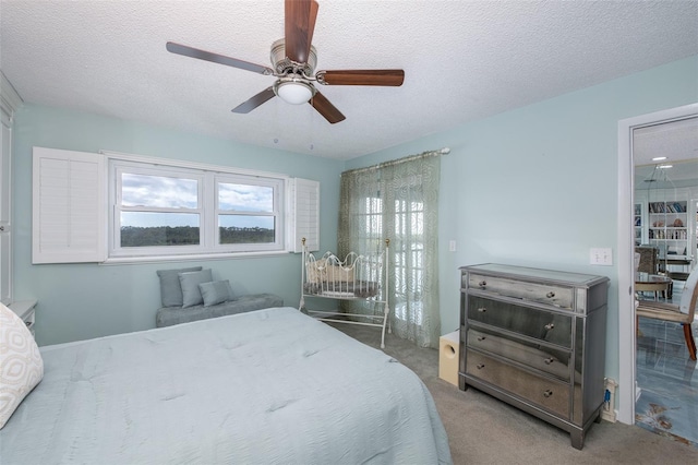 carpeted bedroom featuring a textured ceiling and ceiling fan