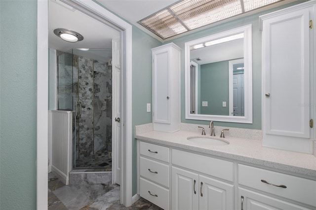 bathroom with a shower with door and vanity