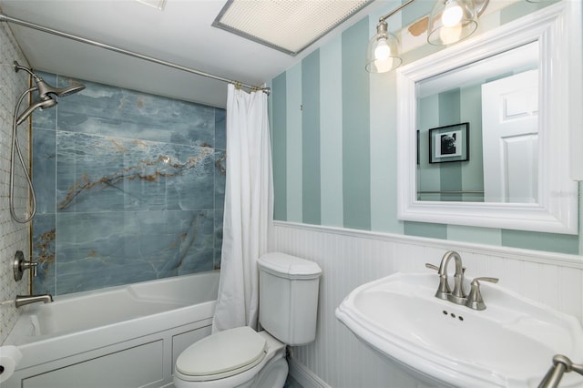 full bathroom featuring sink, shower / bath combination with curtain, and toilet