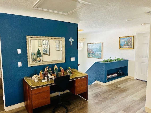 office area with wood-type flooring and a textured ceiling