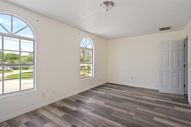 spare room featuring dark hardwood / wood-style floors