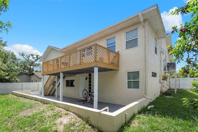 rear view of property featuring a patio area and a deck