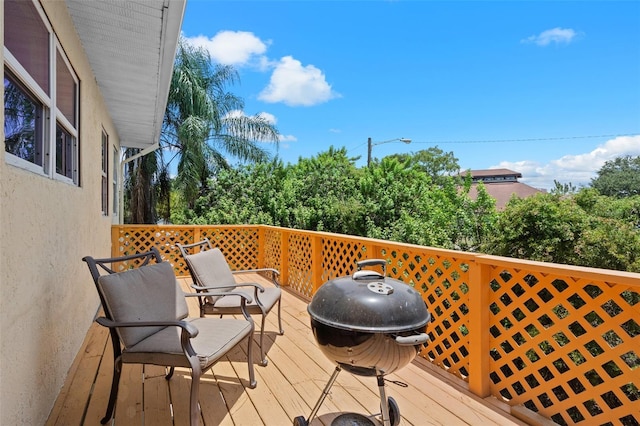 wooden deck with a grill