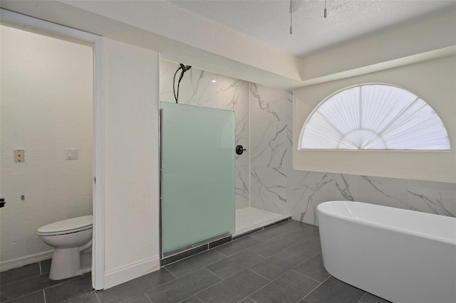 bathroom featuring separate shower and tub, toilet, and a textured ceiling