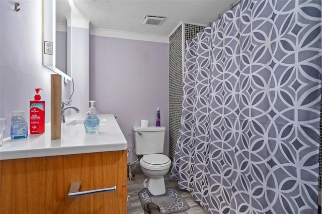 bathroom with crown molding, toilet, a textured ceiling, and vanity