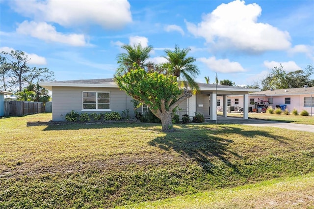 ranch-style home with a front lawn and a carport