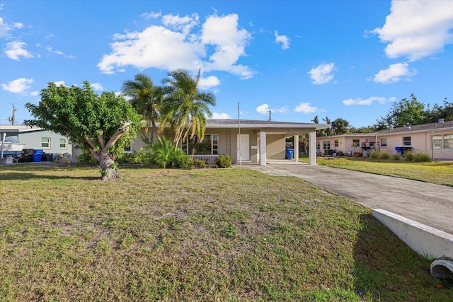 106 Aurora St E, Venice, FL 34285 - view of front of home featuring a carport, a front yard, and concrete driveway