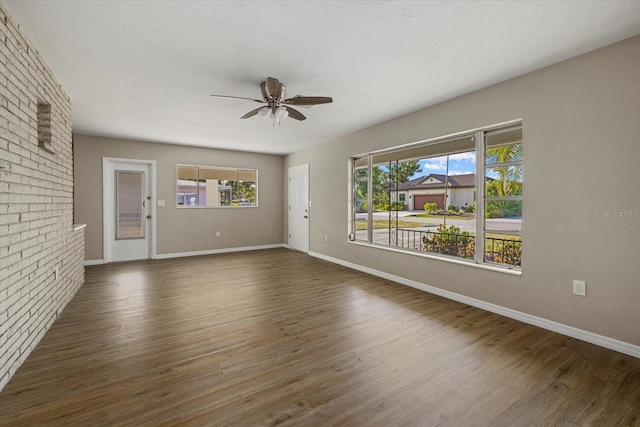 106 Aurora St E, Venice, FL 34285 - unfurnished living room with baseboards, ceiling fan, wood finished floors, and a wealth of natural light