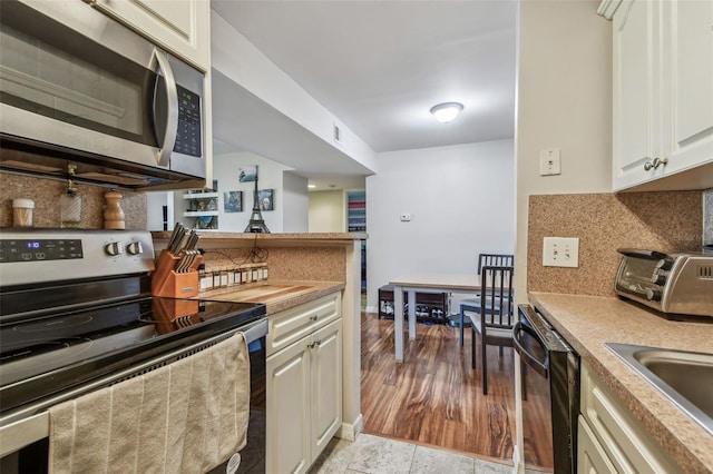 kitchen with decorative backsplash, sink, and appliances with stainless steel finishes