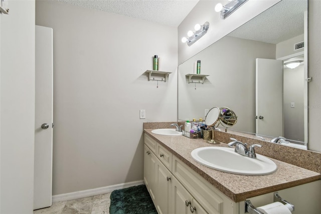 bathroom with vanity and a textured ceiling