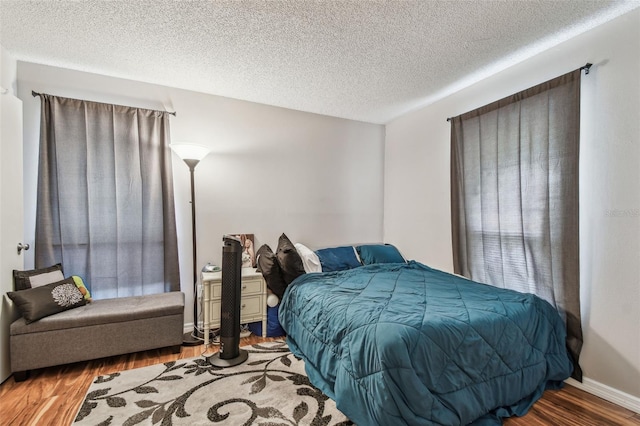 bedroom featuring wood-type flooring and a textured ceiling