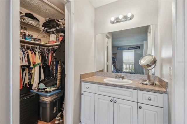 bathroom with a textured ceiling and vanity