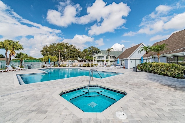 view of swimming pool with a community hot tub and a patio