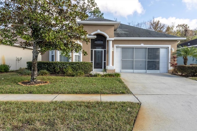 view of front of house with a front yard and a garage