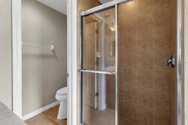 bathroom with tile patterned flooring, an enclosed shower, and toilet