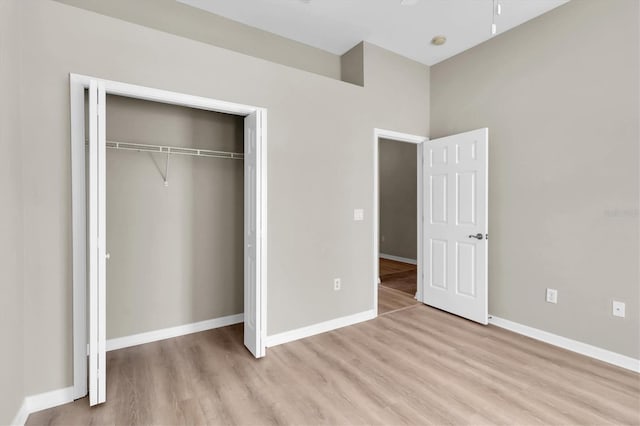 unfurnished bedroom with a closet and light hardwood / wood-style flooring