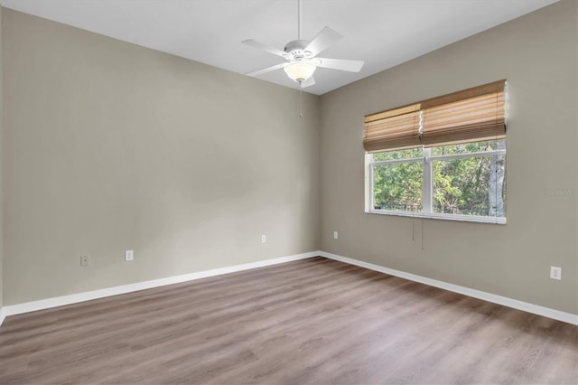 empty room featuring hardwood / wood-style floors and ceiling fan