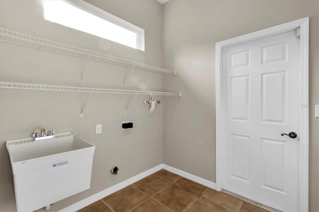 washroom with hookup for an electric dryer, tile patterned floors, and sink