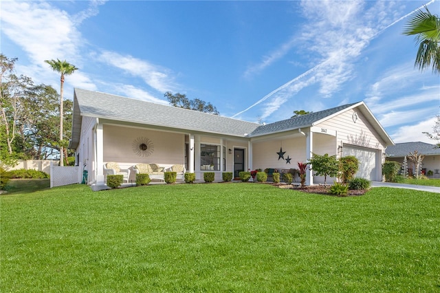 single story home with covered porch, a front yard, and a garage