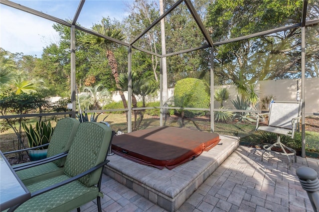 view of patio / terrace with glass enclosure and a covered hot tub