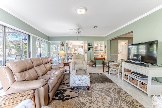 tiled living room featuring ceiling fan and ornamental molding