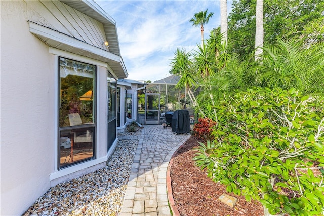 view of patio featuring a lanai