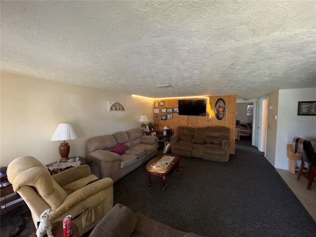 living room with a textured ceiling and dark colored carpet