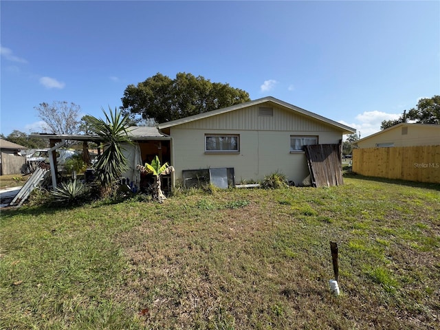 back of property featuring a yard