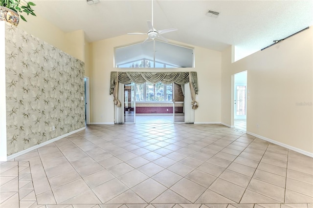 interior space with ceiling fan, light tile patterned floors, and high vaulted ceiling