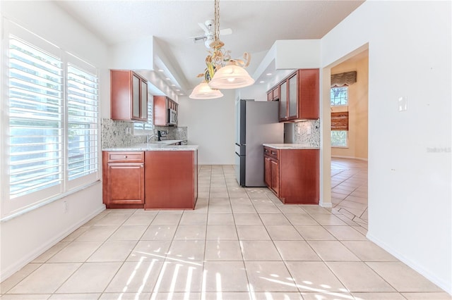 kitchen with decorative backsplash, light tile patterned floors, stainless steel appliances, and a wealth of natural light