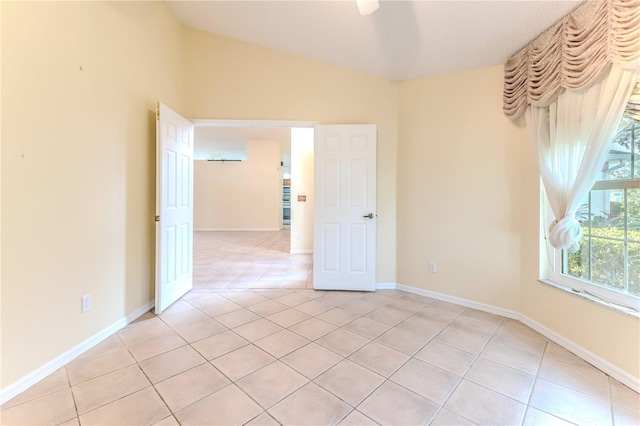 tiled empty room with vaulted ceiling