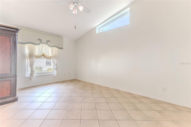 unfurnished room featuring a textured ceiling, ceiling fan, light tile patterned flooring, and vaulted ceiling