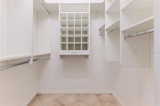 walk in closet featuring tile patterned flooring