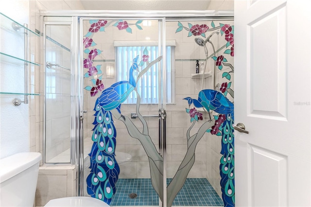 bathroom featuring toilet and an enclosed shower