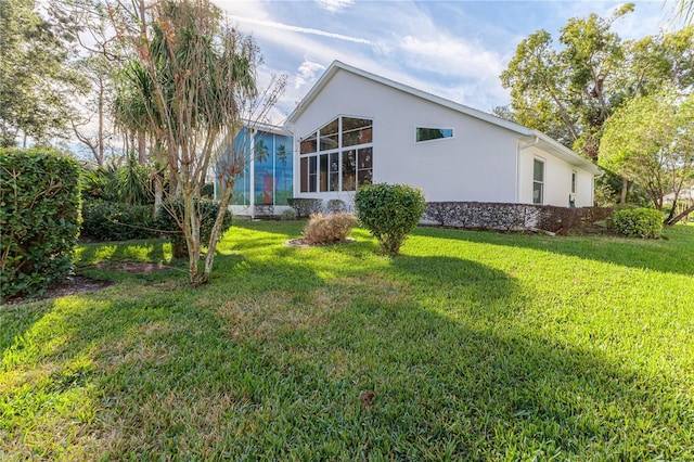 view of side of property featuring a yard