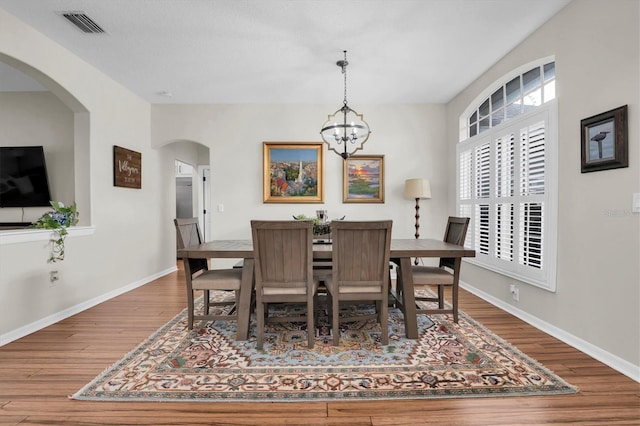 dining area featuring a chandelier and hardwood / wood-style flooring