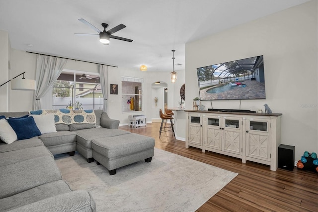 living room featuring ceiling fan and wood-type flooring