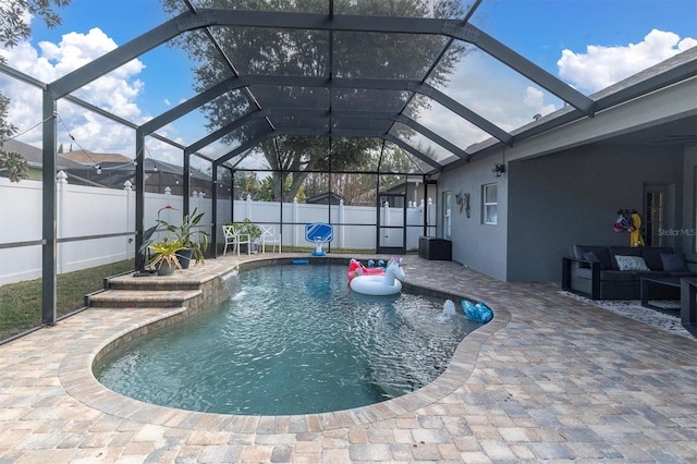 view of pool featuring a patio, glass enclosure, and an outdoor hangout area