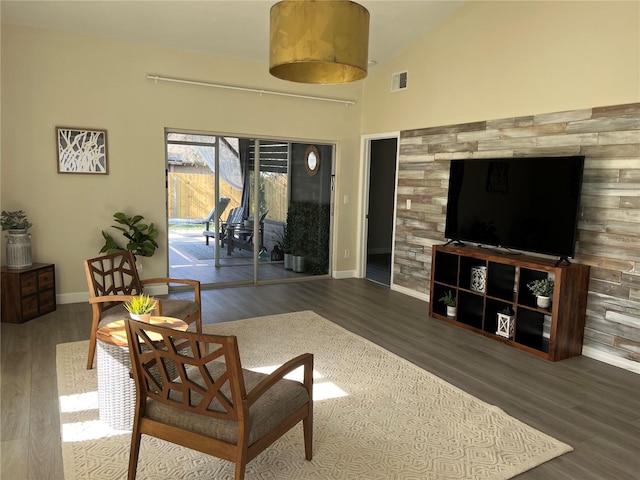 living room featuring dark hardwood / wood-style flooring and high vaulted ceiling