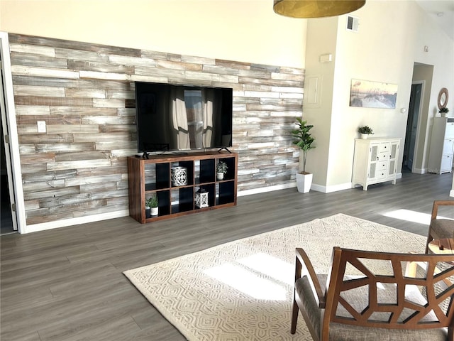 living room featuring lofted ceiling and dark hardwood / wood-style floors