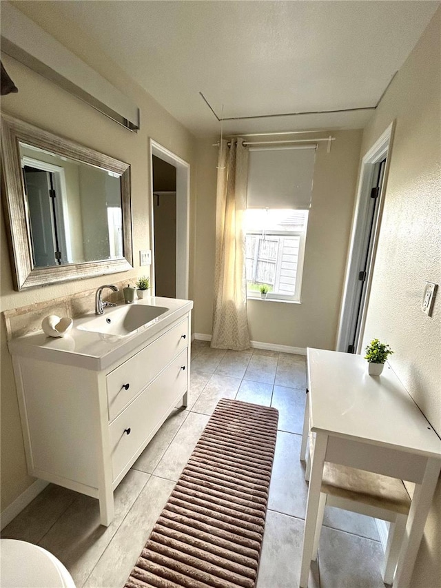 bathroom featuring tile patterned flooring, vanity, and toilet