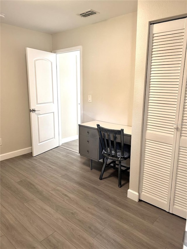 home office with dark wood-type flooring