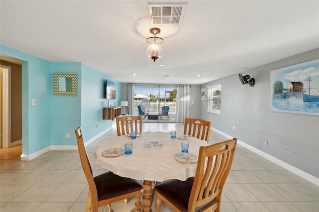 dining area with light tile patterned flooring